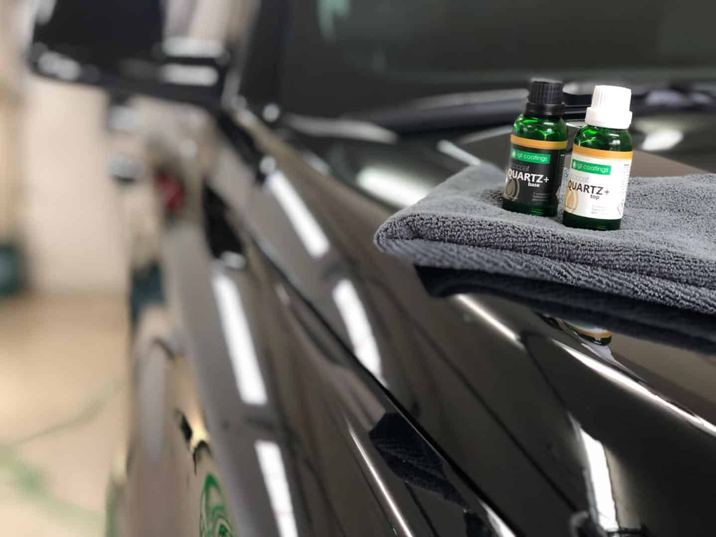 IGL ceramic coating bottles resting on freshly coated black paint