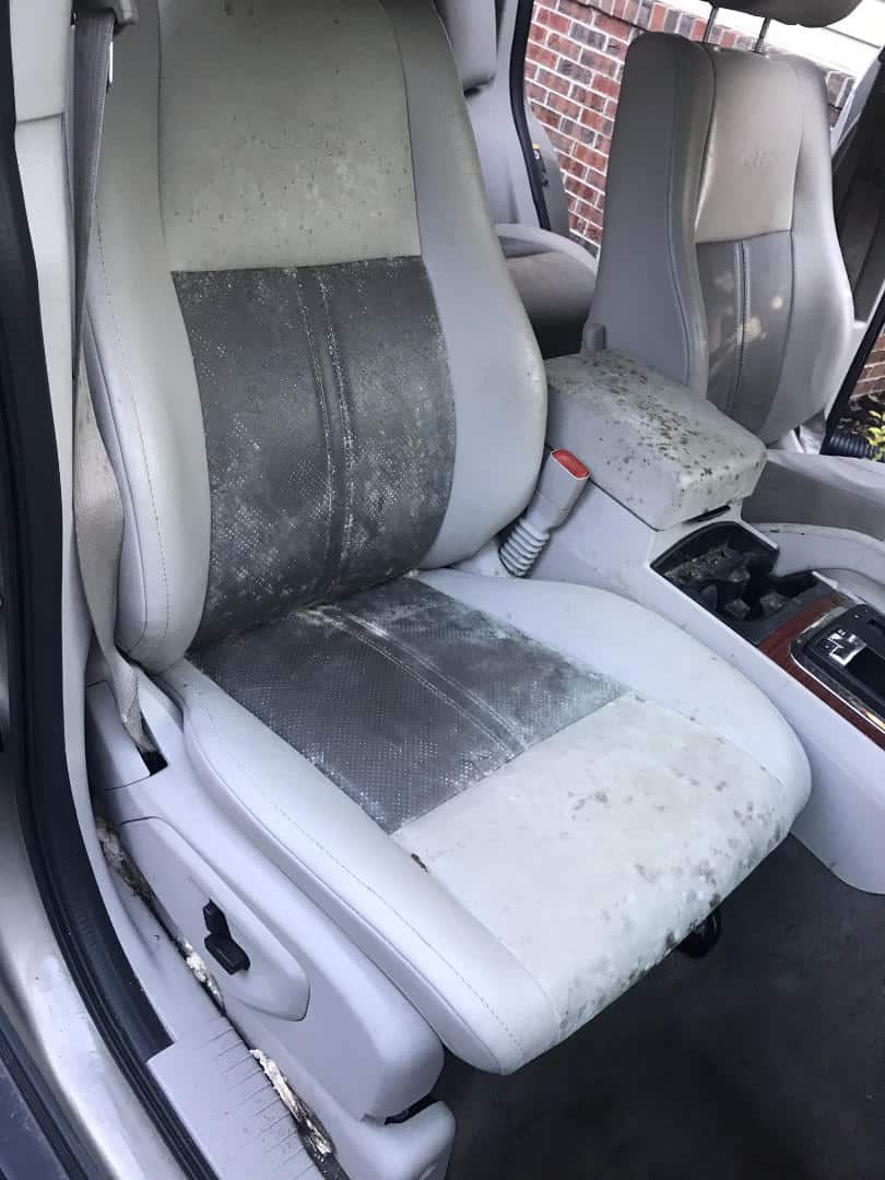 Stained cloth seat before odor and stain treatment